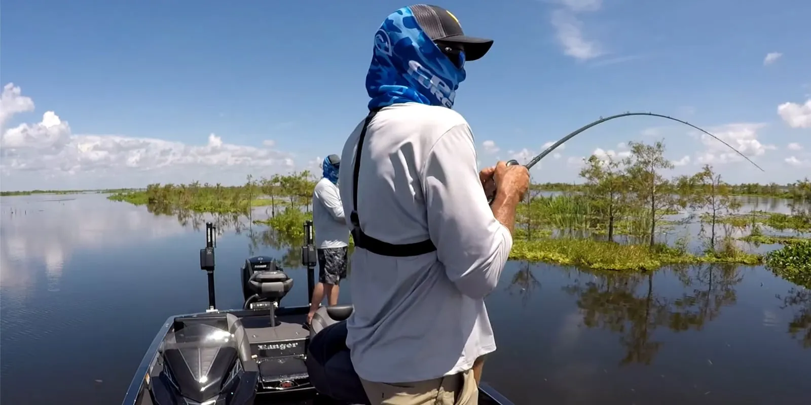 An explosive topwater strike from a bass in the pristine, grassy habitat of Fellsmere Reservoir
