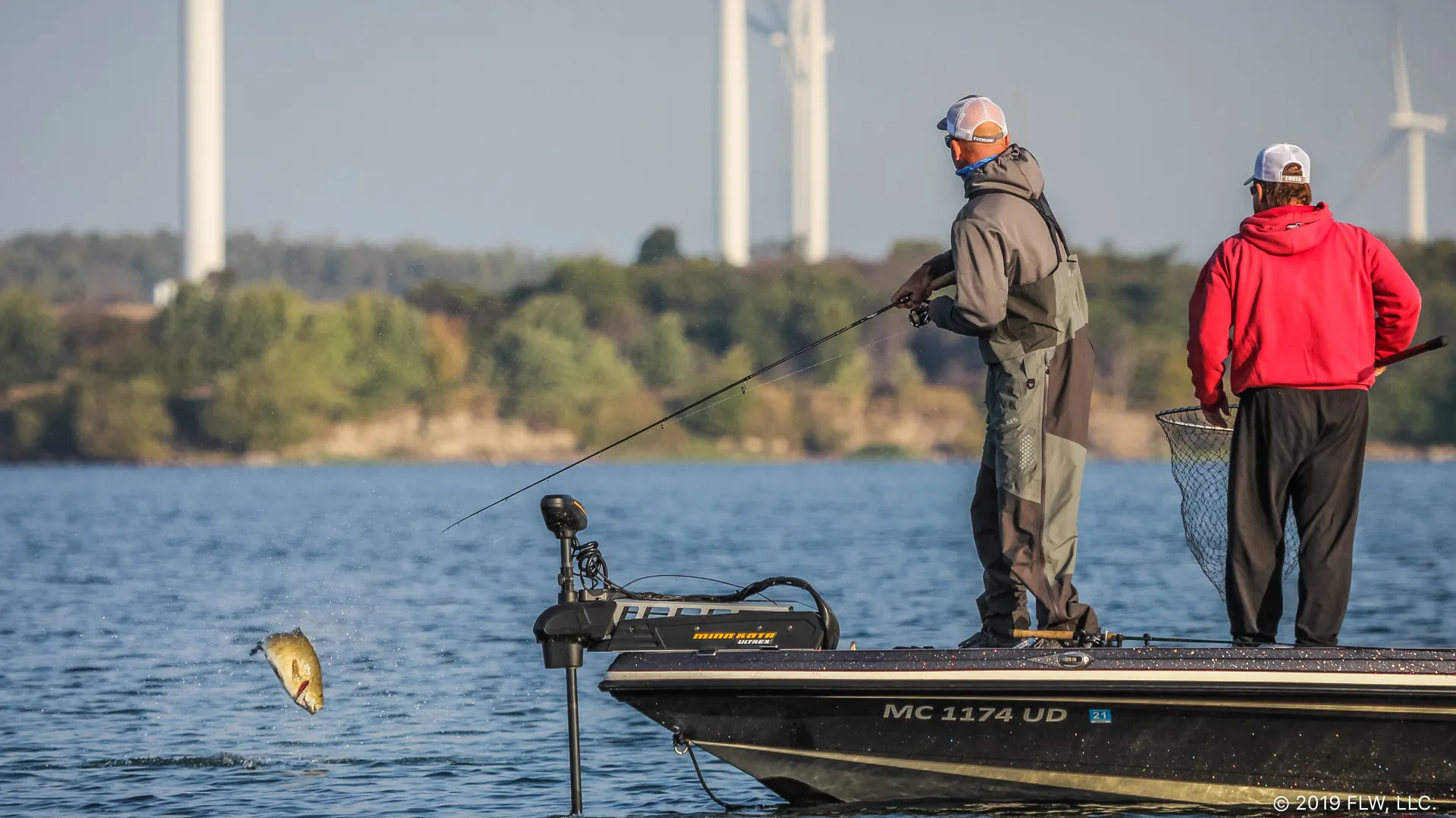 A stunning shot of the Thousand Islands region on the St. Lawrence, with an angler fighting a smallmouth.